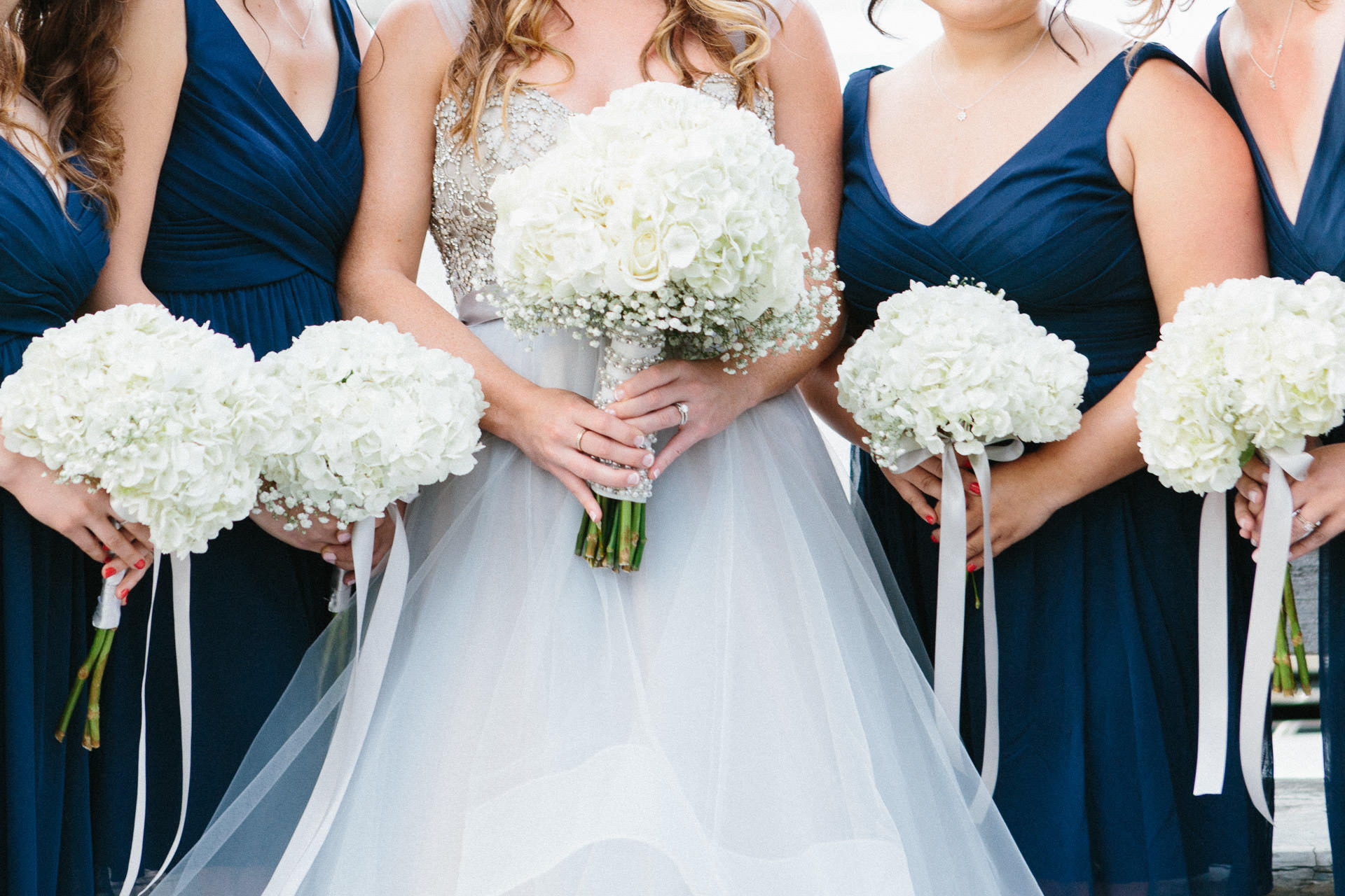 Bride and bridesmaids holding their floral bouquets