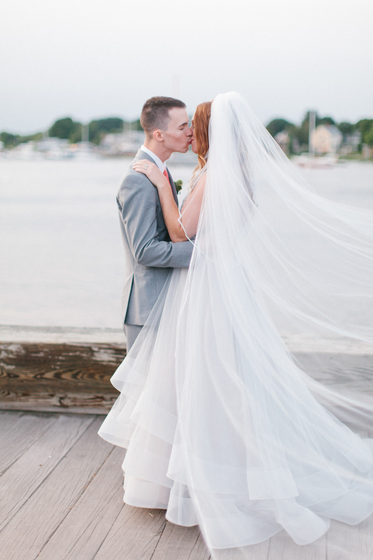Bride and Groom kissing for a photograph during their wedding at the Custom House Maritime Museum in Newburyport, MA