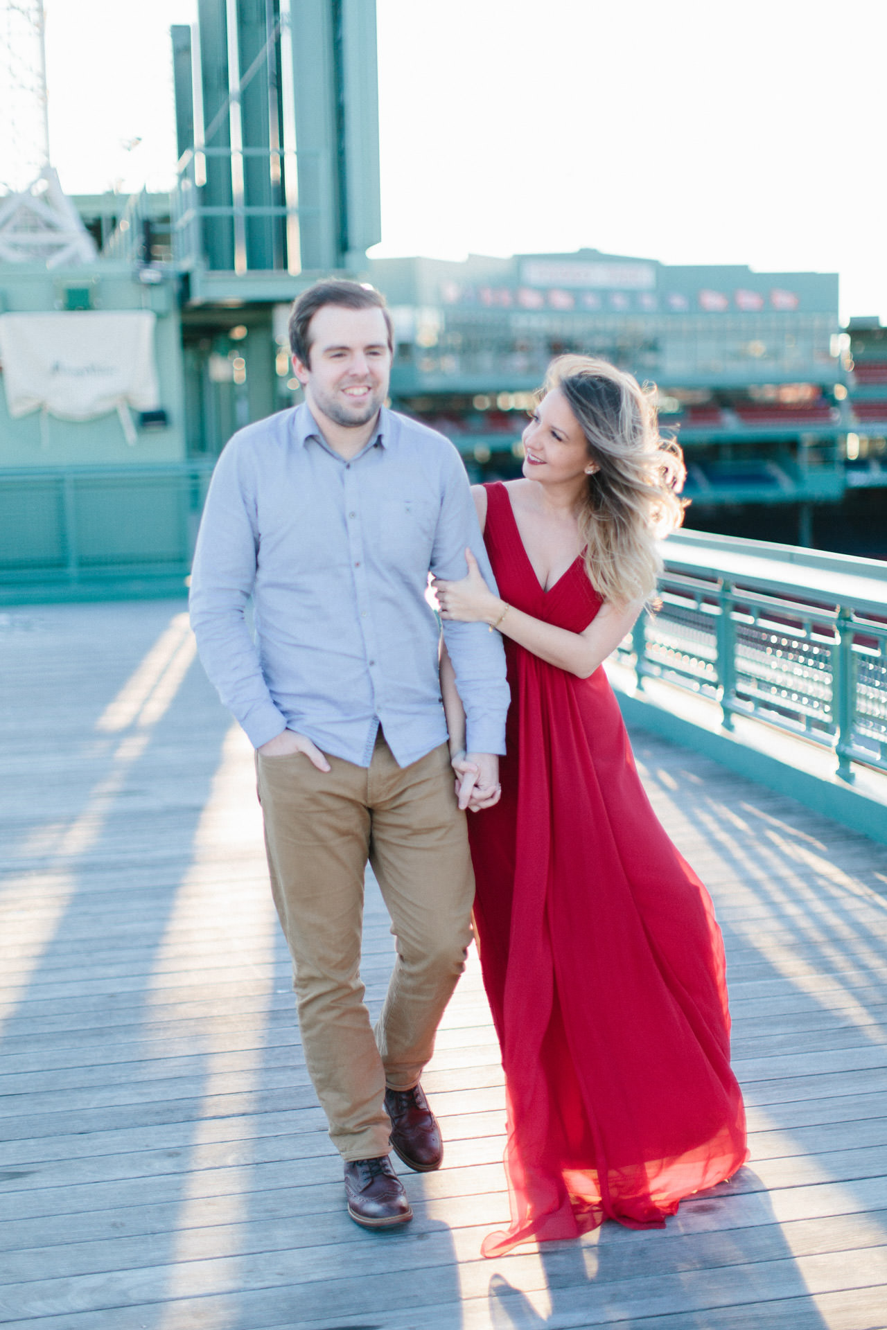 Engaged couple walking in Fenway Park in Boston, MA