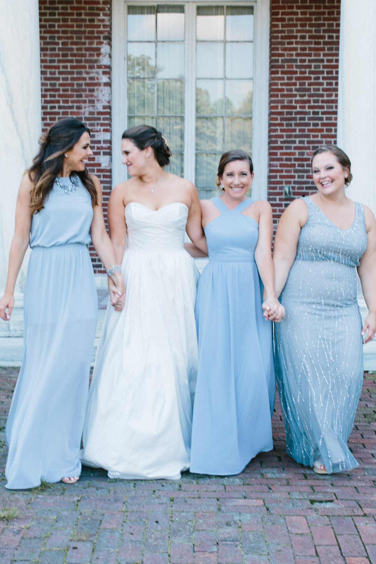 Bride and bridesmaids smiling during her Boston wedding