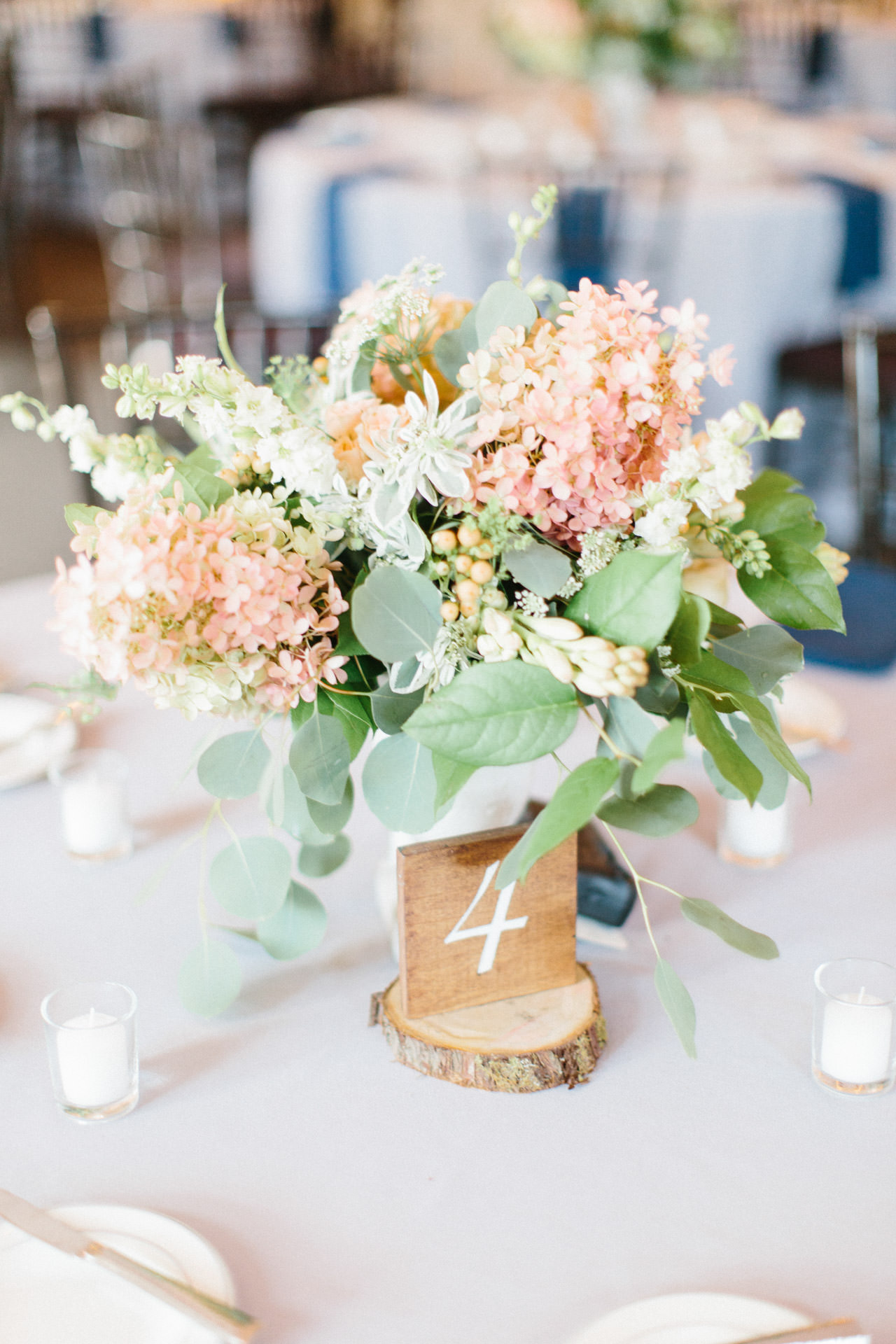 Green, pink, and orange floral centerpiece on a table