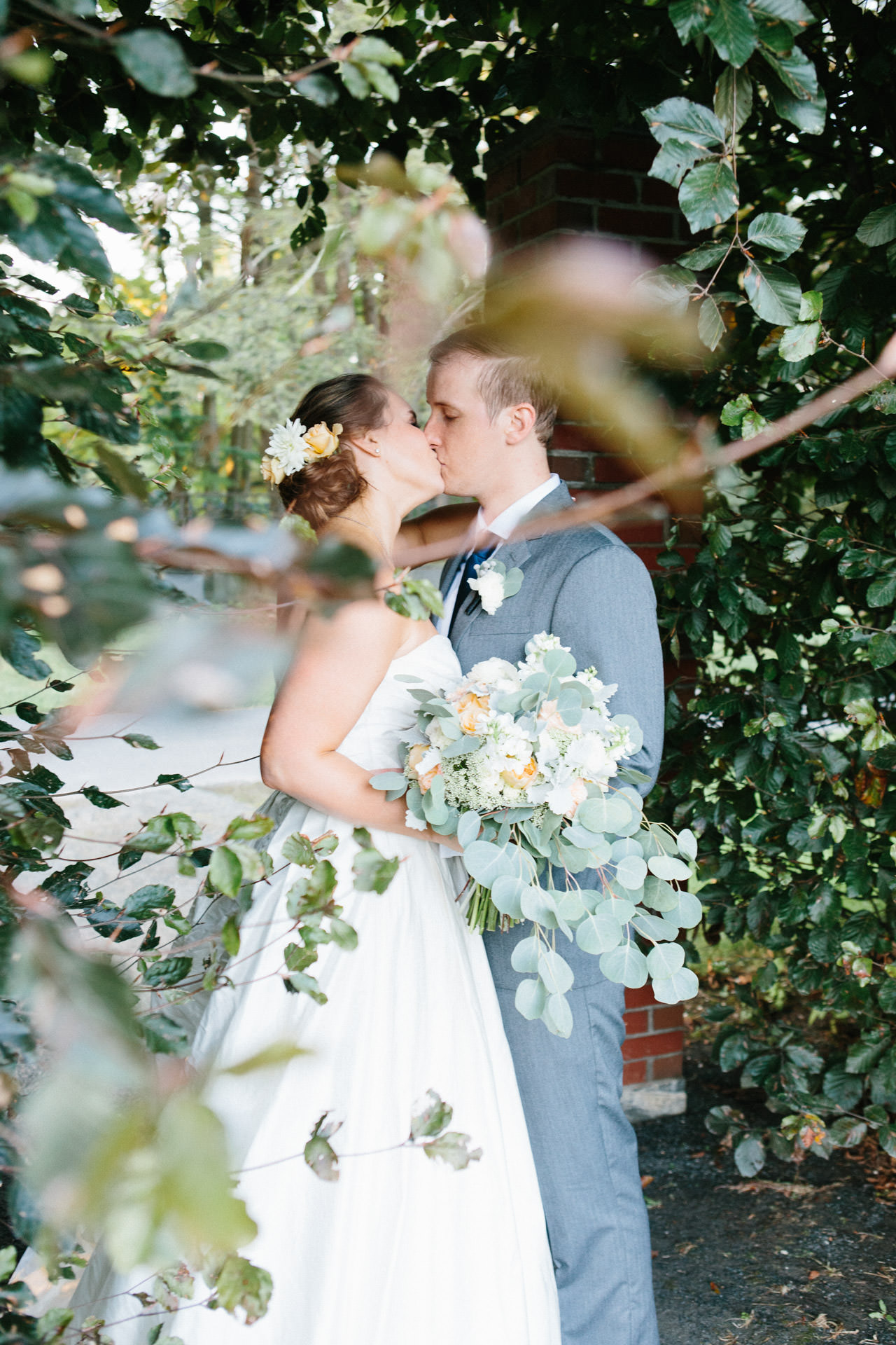 Husband and wife kissing in a garden