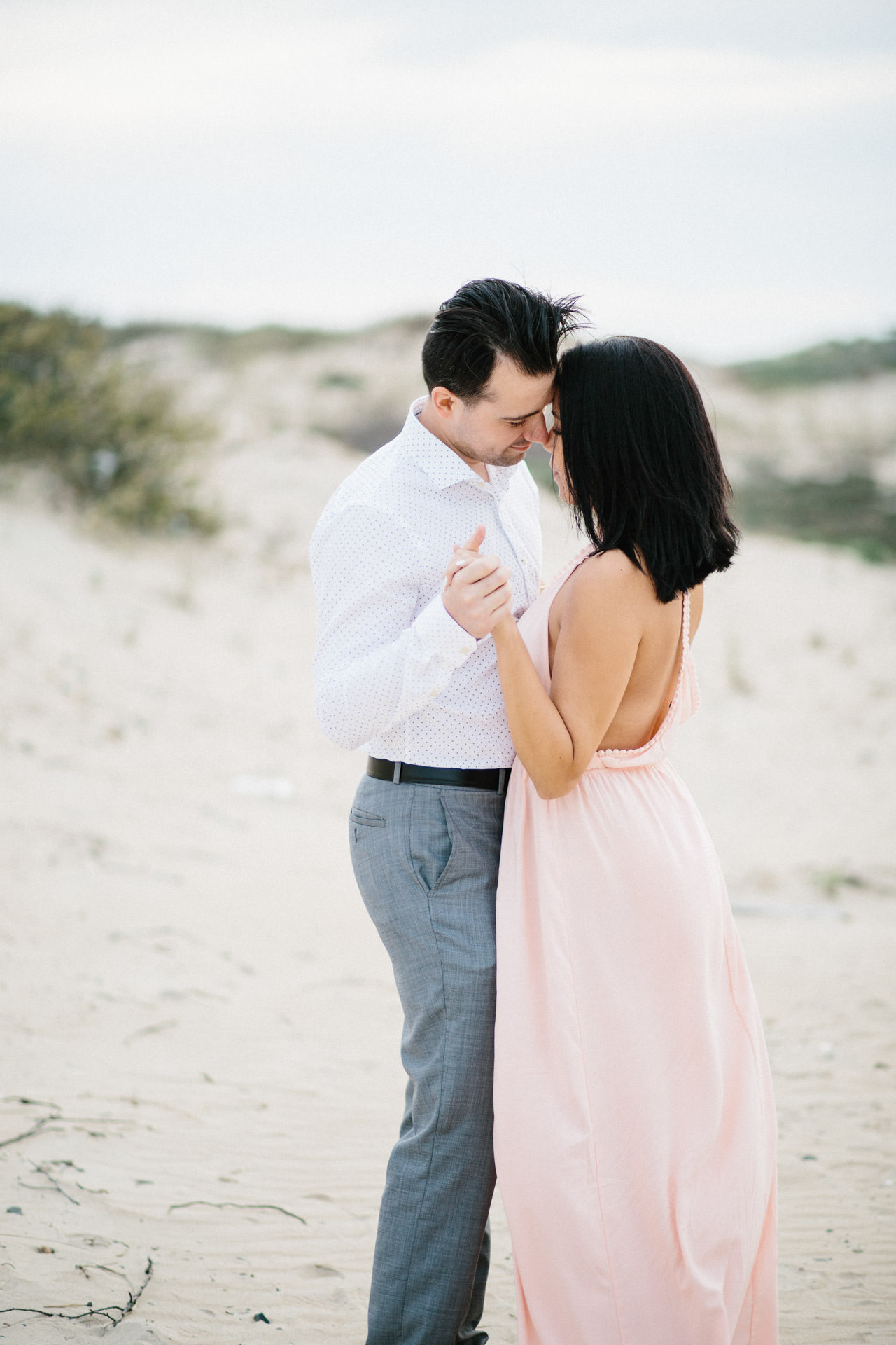 Couple posing for an engagement photograph at Horseneck Beach in Westport, MA