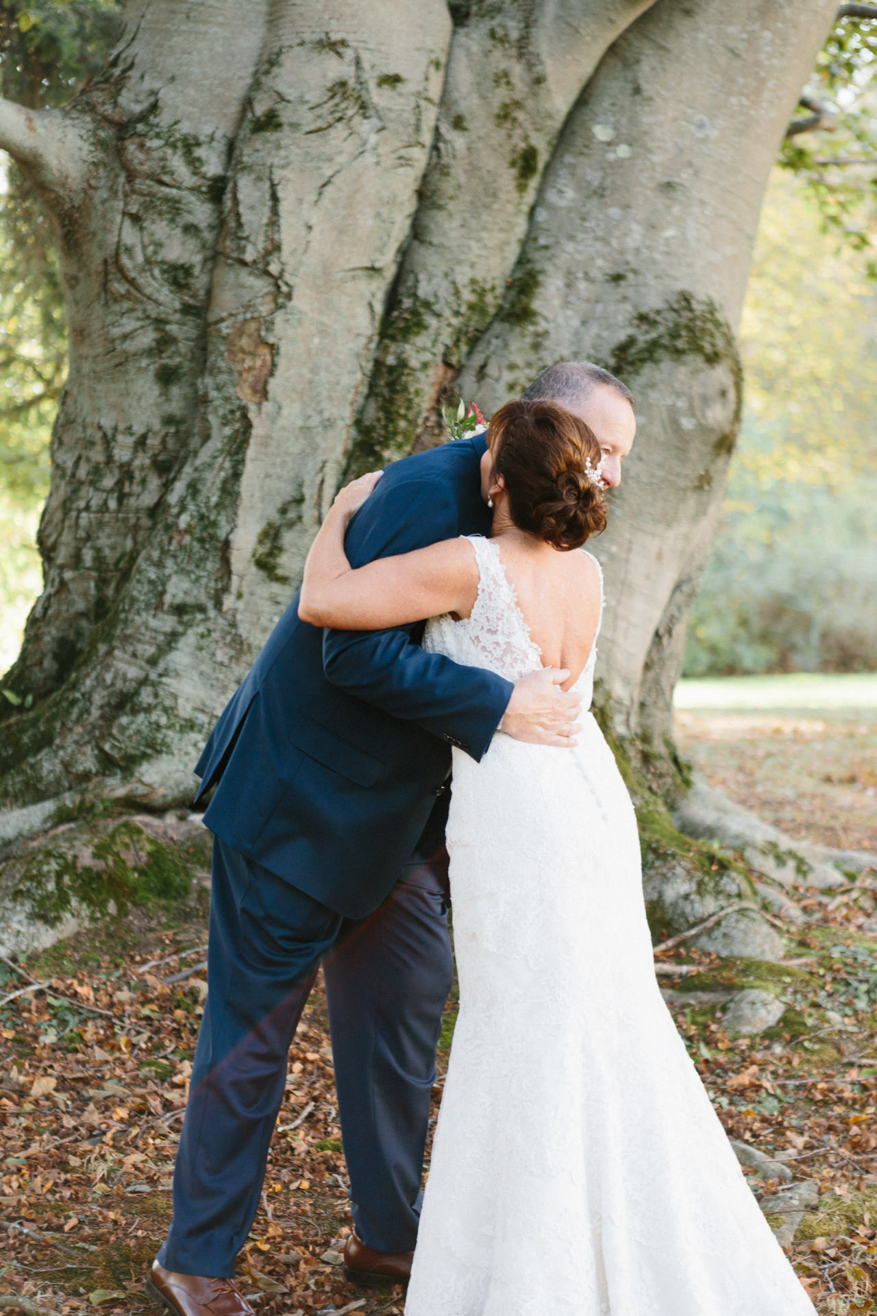 Bride and groom embracing and posing for a photograph