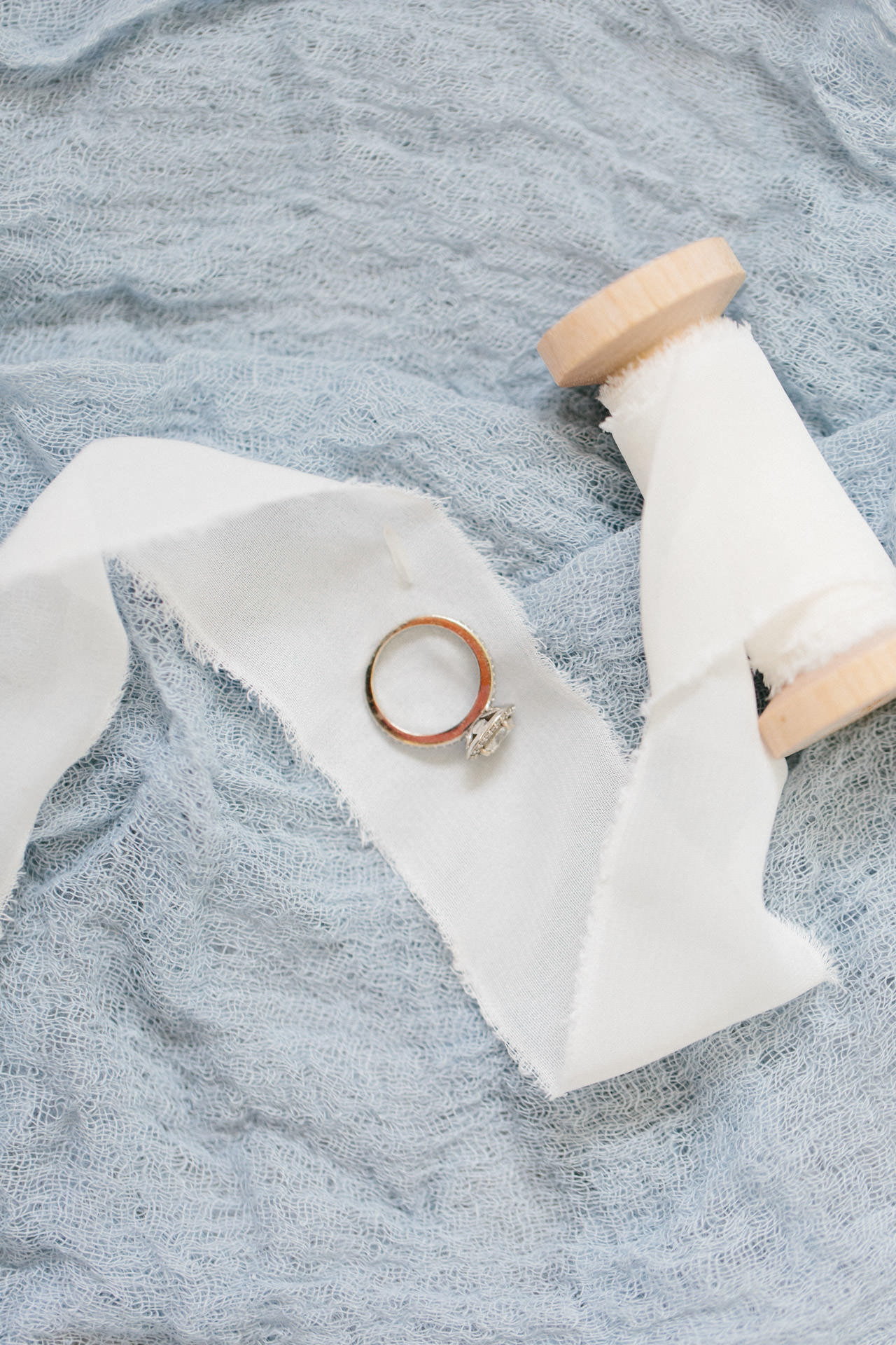 Wedding ring laying on linen