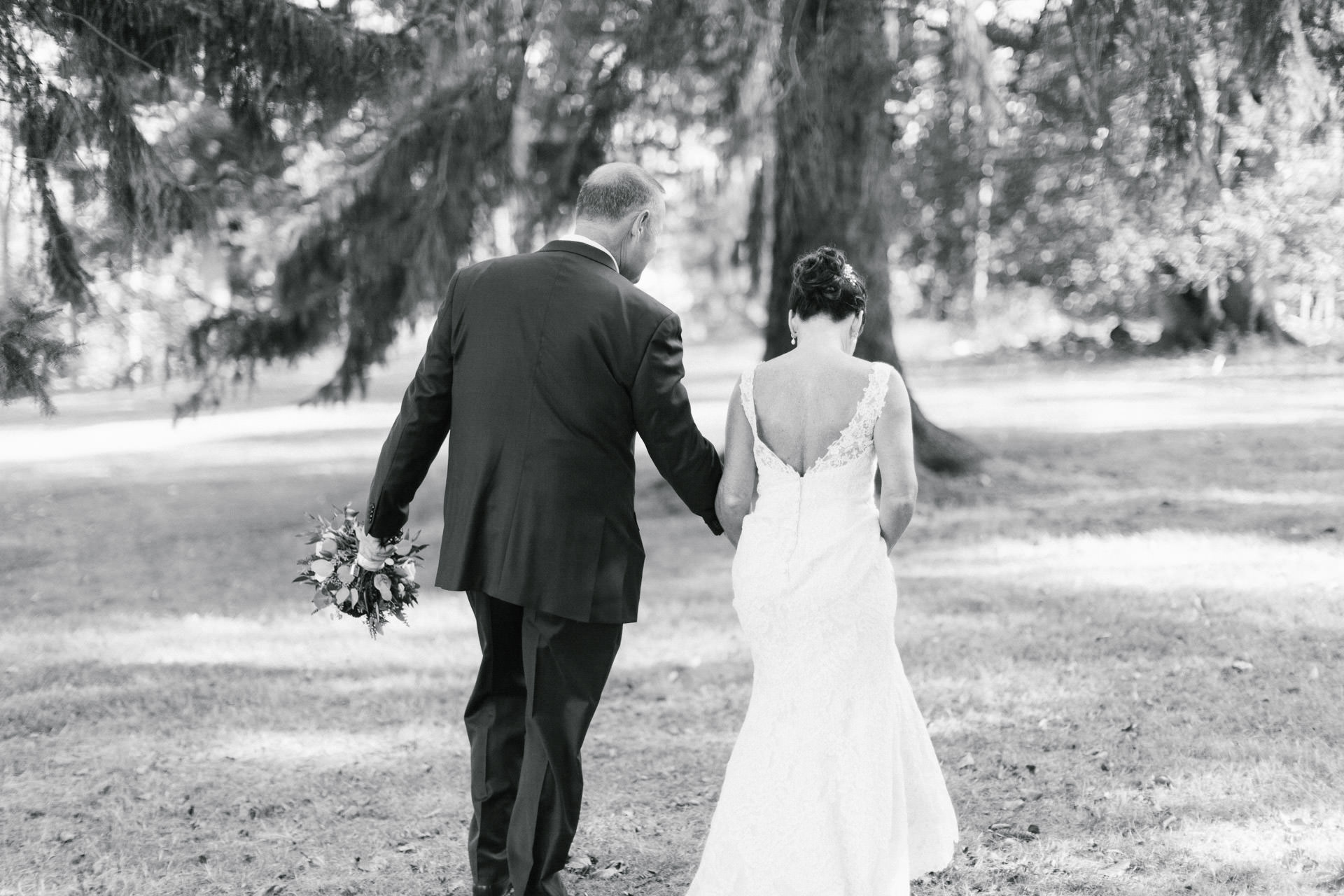 Bride and Groom holding hands and walking