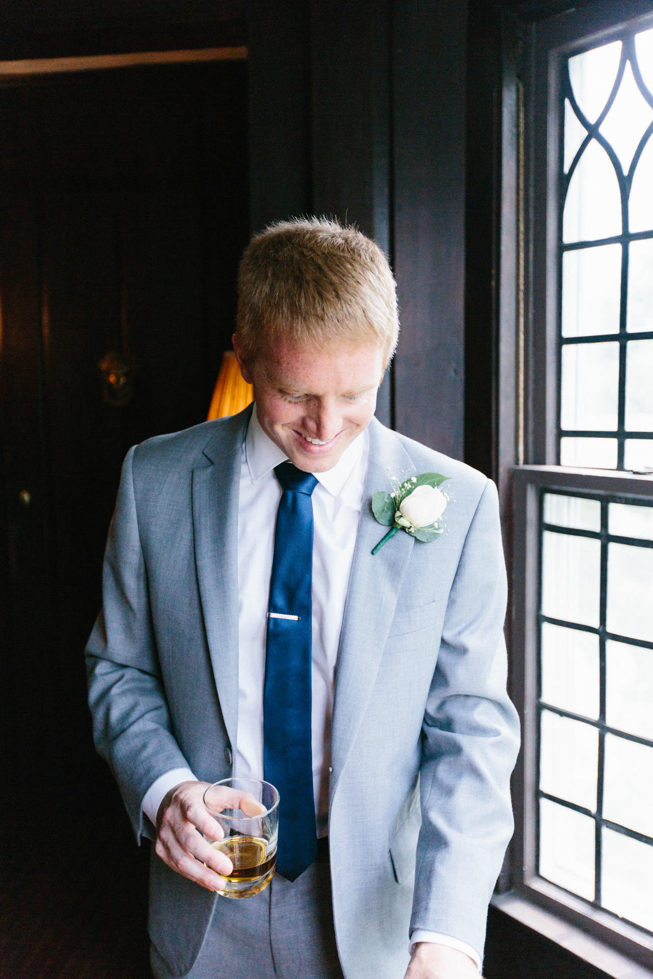 Groom posing for a photograph during his Boston wedding at Peirce Farm at Witch Hill in Topsfield, MA