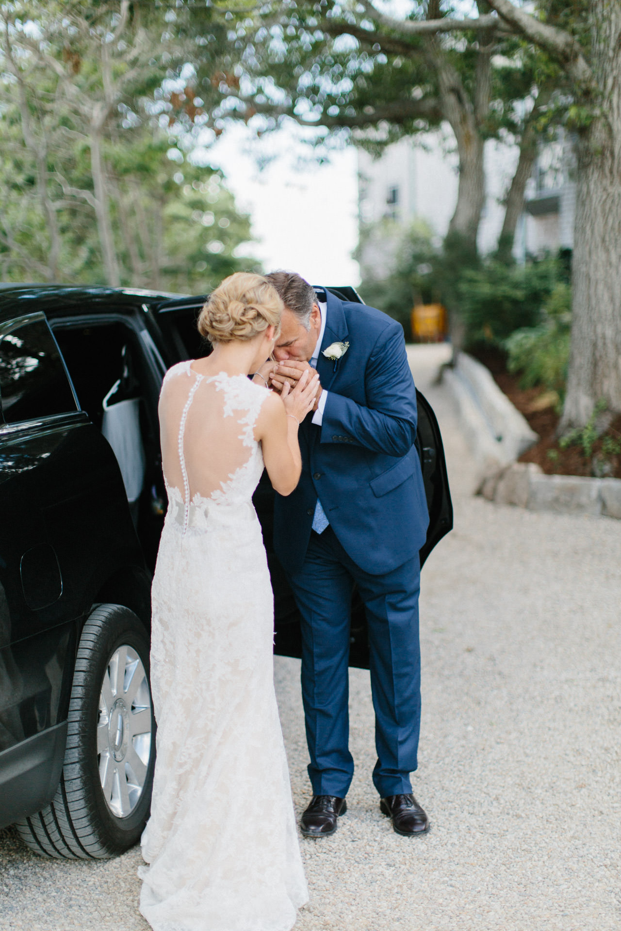 Bride's father kissing her hands at The Coonamessett Inn in Falmouth, MA