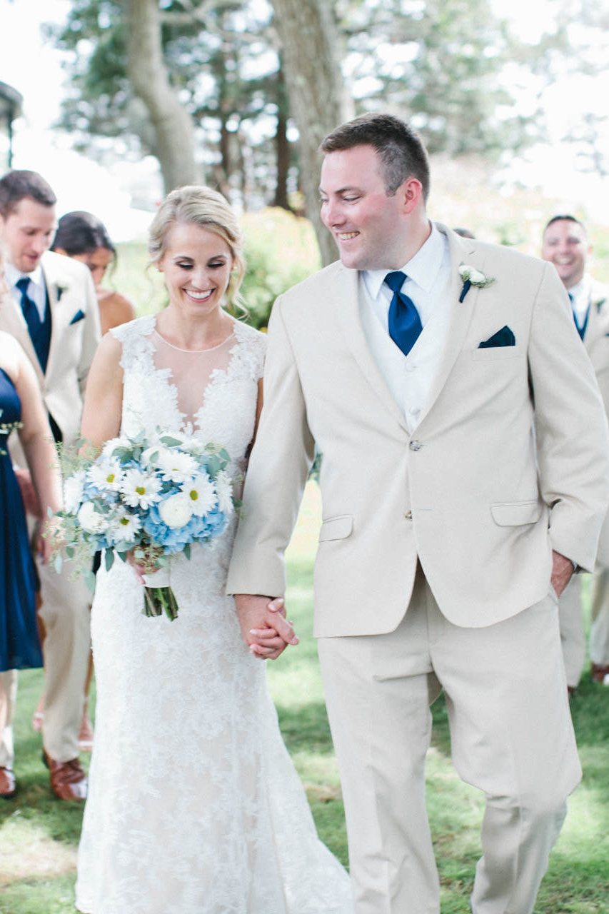 Bride and Groom holding hands during their wedding at The Coonamessett Inn in Falmouth, MA