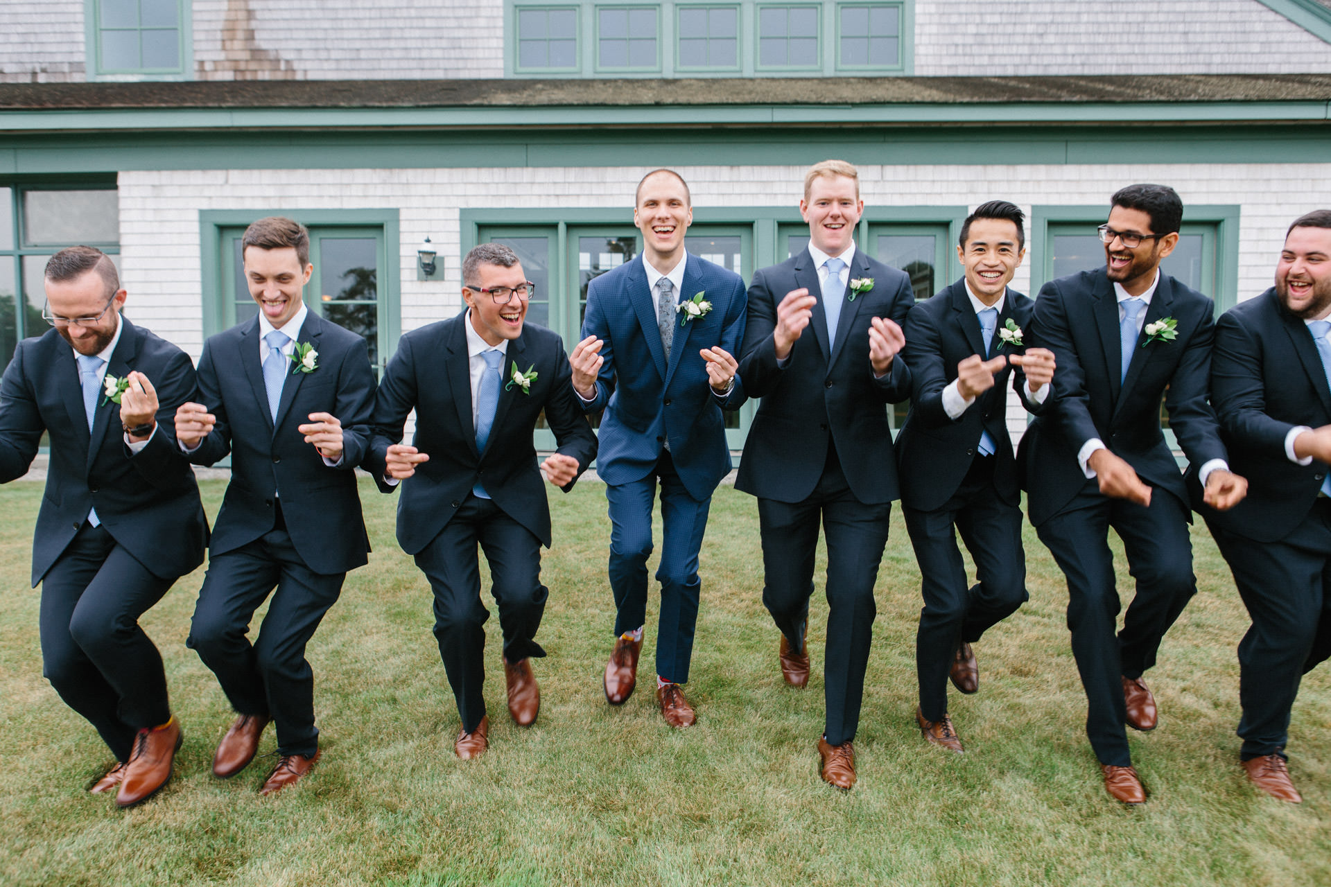 Groom and groomsmen laughing at the Waverly Oaks Golf Club in Plymouth, MA