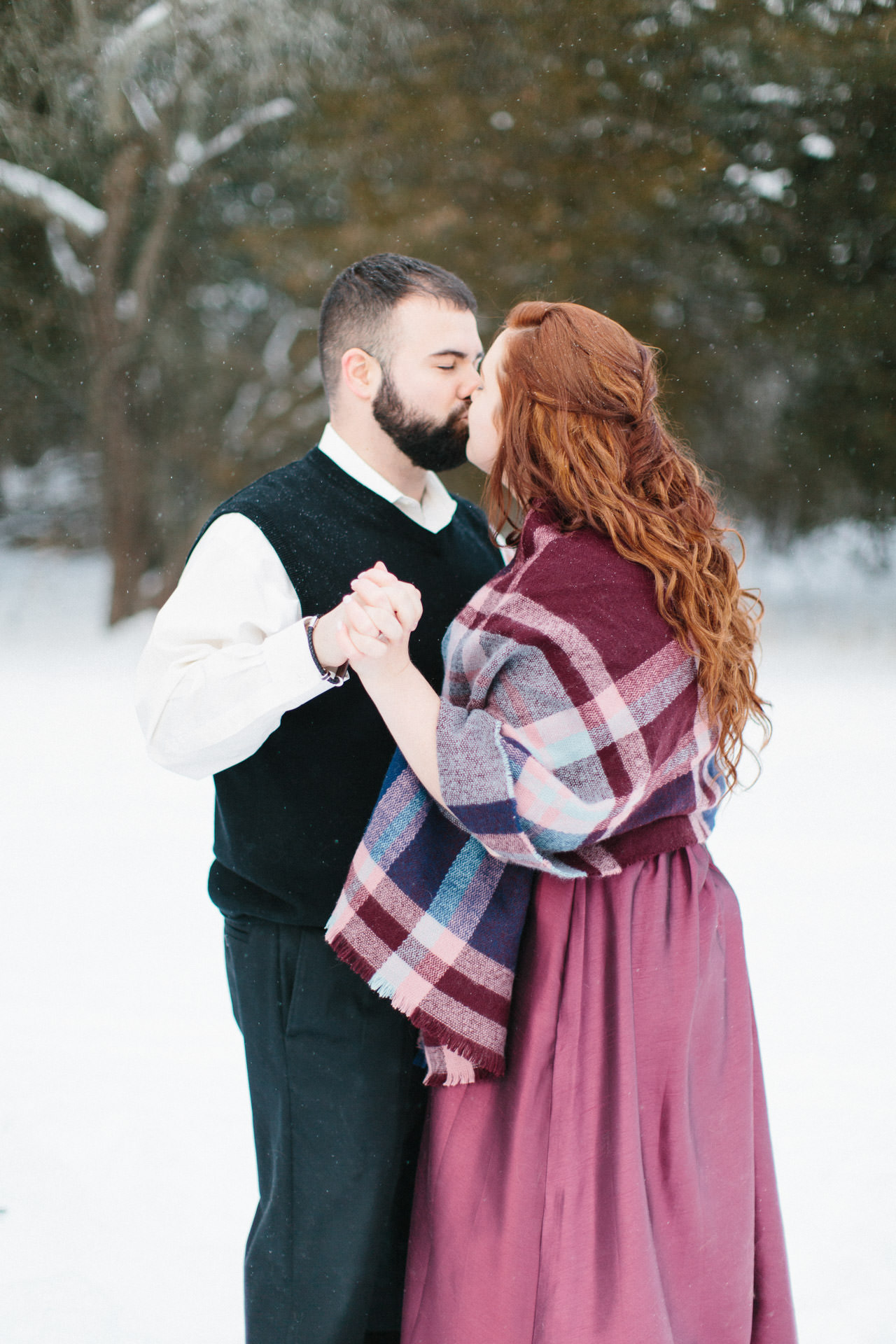 Bride and groom kissing in the snow